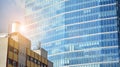 Blue curtain wall made of toned glass and steel constructions under blue sky. A fragment of a building. Royalty Free Stock Photo