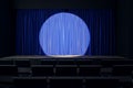 Blue curtains under spotlight in an empty theater setting. Royalty Free Stock Photo