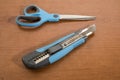 Blue cutter and scissor on a wood table