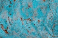 Blue cyan color facade stone wall with imperfections, holes and cracks as an empty rustic and simple texture background Royalty Free Stock Photo