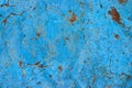 Blue cyan color facade stone wall with imperfections, orange red holes and cracks as an empty rustic and simple texture background Royalty Free Stock Photo