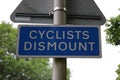 Blue Cyclists Dismount road sign UK