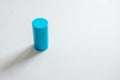 Blue cylindrical object, minimalist background