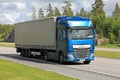 Blue DAF XF semi trailer road transport at summer