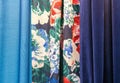 Blue and dark blue curtains on the edges and a bright with floral ornament curtain in the middle Royalty Free Stock Photo