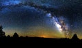 Blue dark night sky with many stars above field of trees. Yellowstone park. Milkyway cosmos background