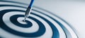 Blue Dart Hitting Bullseye on White Surface Symbolizing Precision and Success Royalty Free Stock Photo
