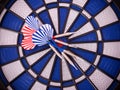 Blue dartboard with darts