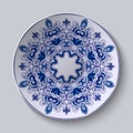 Blue decorative ornament. Pattern is applied on a ceramic plate.