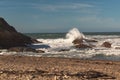 Blue deep sea waves crashing against the rocky shore Royalty Free Stock Photo