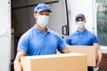 Blue Delivery Men Unloading Package From Truck
