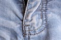 Blue denim. Cotton fabric, jeans. Creative vintage background. Pocket and zipper. The line is of poor quality. Cheap item Royalty Free Stock Photo