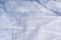 Blue denim. Cotton fabric, jeans. Creative vintage background. Pocket and zipper. The line is of poor quality. Cheap item Royalty Free Stock Photo