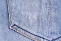 Blue denim. Cotton fabric, jeans. Creative vintage background. Pocket and zipper. The line is of poor quality. Cheap item Royalty Free Stock Photo