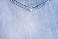 Blue denim. Cotton fabric, jeans. Creative vintage background. Pocket and zipper. The line is of poor quality. Cheap item Royalty Free Stock Photo