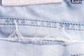 Blue denim. Cotton fabric, jeans. Creative vintage background. Pocket and zipper. The line is of poor quality. Cheap item Royalty Free Stock Photo