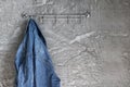 Blue denim jacket on the coat hanger on the old plaster wall. Royalty Free Stock Photo
