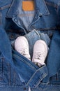 Blue denim jacket, white leather sneakers, on a white background. Clean branded clothing. Mock up for your design. Spring Summer
