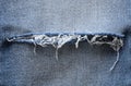 Blue denim jeans background. ripped detail. Texture, close up Royalty Free Stock Photo