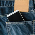 Blue denim Jeans pocket with mobile phone. Royalty Free Stock Photo