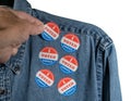 Blue denim working clothing with many Voted stickers on white background