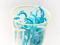 Blue dental floss sticks in plastic cup Royalty Free Stock Photo