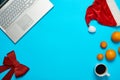 Blue desk with laptop, office items coffe and Santa cup Royalty Free Stock Photo