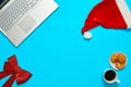 Blue desk with laptop, office items coffe and Santa cup Royalty Free Stock Photo