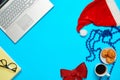 Blue desk with laptop, office items coffe and Santa cup Royalty Free Stock Photo