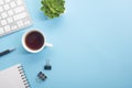 Blue desk office with laptop, smartphone and other work supplies with cup of coffee. Top view with copy space for input Royalty Free Stock Photo