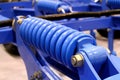 Blue detail of the spring shock absorber is a mechanical transport element Royalty Free Stock Photo