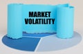 On the blue diagram is a twisted paper sign with the inscription - Market Volatility