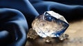 a blue diamond and some crystal stones on a blue cloth