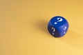 Blue dice with question mark on yellow background