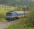 Blue diesel train with passengers coach in Jeseniky mountains Royalty Free Stock Photo