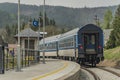 Blue diesel train with passengers coach in Jeseniky mountains