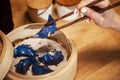 Blue Dim Sum chinese cuisine in bamboo steamer and pot. Top view fresh dumplings with hot steams on wood plate with Royalty Free Stock Photo