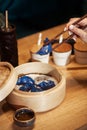 Blue Dim Sum chinese cuisine in bamboo steamer and pot. Top view fresh dumplings with hot steams on wood plate with Royalty Free Stock Photo