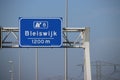 Blue direction sign on motorway A12 heading to Den Haag and Zoetermeer in the Netherlands