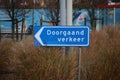 Blue direction sign in the netherlands for ongoing traffic in the harbor of Rotterdam.