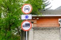 Blue direstional Roundabout road signs about forbidden traffic, slippery road on city street at day. Urban