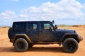Blue dirty sport car in the Guajira desert in Riohacha, Colombia