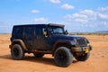 Blue dirty sports car in the Guajira desert in Riohacha, Colombia