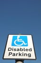 Blue Disabled Parking sign against blue sky. Royalty Free Stock Photo