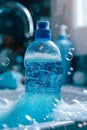 Blue dish soap bottle amidst soap suds and water sparkle. Royalty Free Stock Photo