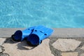 Blue diving fins on the stone terrace at the pool, concept for leisure activities during the holidays, copy space Royalty Free Stock Photo