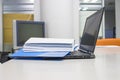 Blue Document folder with documents and Laptop on white table Royalty Free Stock Photo