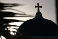 Blue dome of church as silhouette again the sunrise in Santorini, Greece