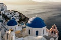 Blue dome churches in Oia village, photo taken at sunrise. Royalty Free Stock Photo