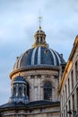 Blue dome under golden sunset light in Paris, France. Golden details glow under the golden light